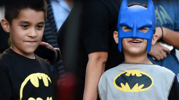 Twin brothers Augustine, left, and Vincent Reynoso, of Rancho Cucamonga, California, dress in Batman outfits at a tribute to "Batman" star Adam West in Los Angeles.