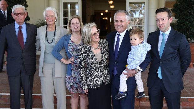 Prime Minister Malcolm Turnbull with his grandson Jack, wife Lucy, his daughter Daisy, son in law James Brown and parents-in-law Tom and Christine Hughes at Government House following his swearing in.