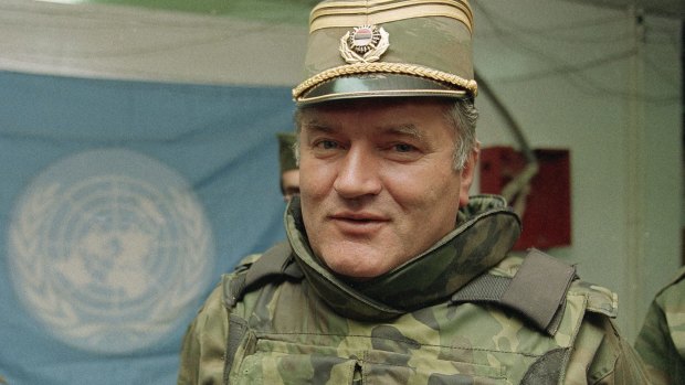Ratko Mladic is pictured near a United Nations flag at Sarajevo Airport in 1993.