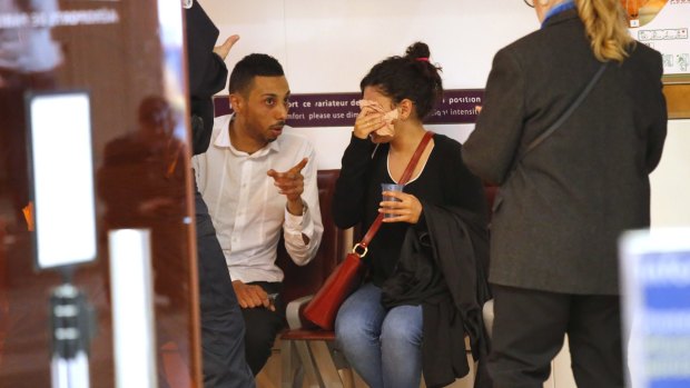 A relative of the victims of the EgyptAir flight 804 wipes her tears as she is comforted at Charles de Gaulle Airport outside of Paris.