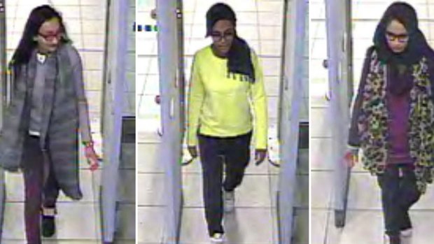 British teenagers Kadiza Sultana, Amira Abase and Shamima Begum passing through security barriers at Gatwick Airport, south of London, on February 17, 2015. 