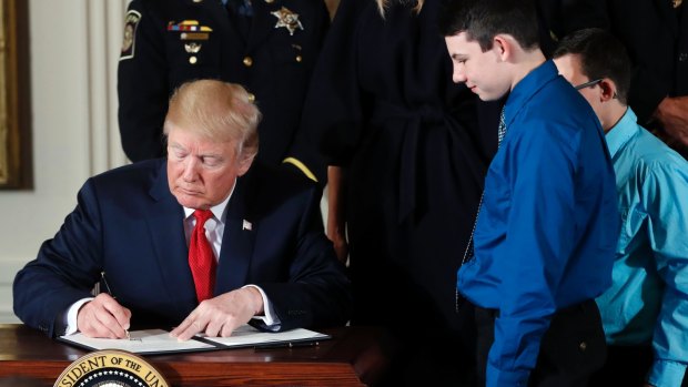 US President Donald Trump signs a presidential memorandum declaring the opioid crisis a public health emergency.