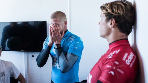 Shaken: Mick Fanning holds his head in his hands taking the gravity of the situation after being attacked by a shark during the JBay Open.