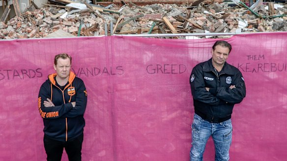 Trades Hall secretary Luke Hilakari, left, and CFMEU boss John Sekta in front of pub's remains. Unions last week banned construction on the site. 
