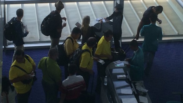 In transit: the refugees at Kuala Lumpur airport on the way  to impoverished Cambodia from Nauru.