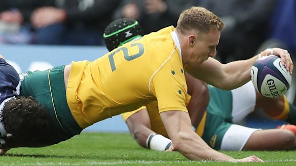 Reece Hodge scores Australia's first try against Scotland.