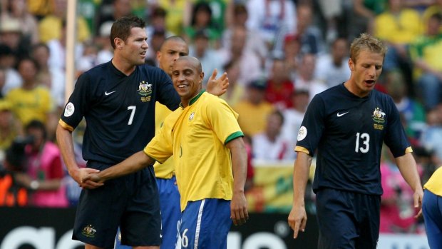 Brazil legend Roberto Carlos, seen here with Socceroos Brett Emerton and Vince Grella, may be the next high-profile coach in the A-League.