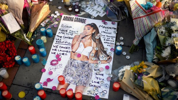 Tributes left in St Ann's Square for the people who died in last week's terror attack at the Manchester Arena.
