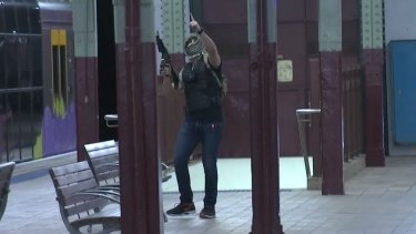 One of the "terrorists" with a semi-automatic assault rifle at Central Station.
