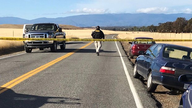 Crime tape blocks off Rancho Tehama Road leading into the Rancho Tehama subdivision south of Red Bluff, California. 