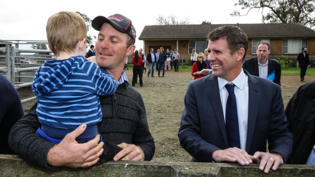 Mike Baird talks to  Woodville dairy farmers David Vollmer and his son Thomas.