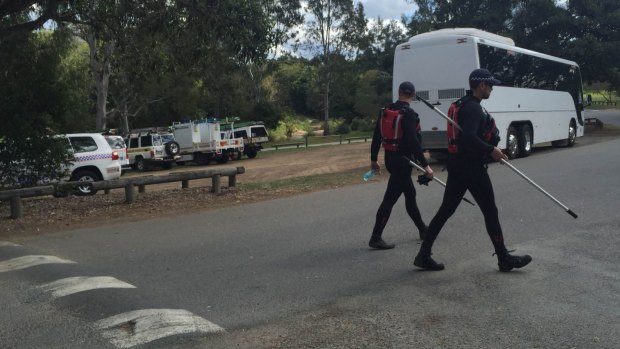 Search crews scour the Kedron Brook creek area for a missing teenager on Monday.
