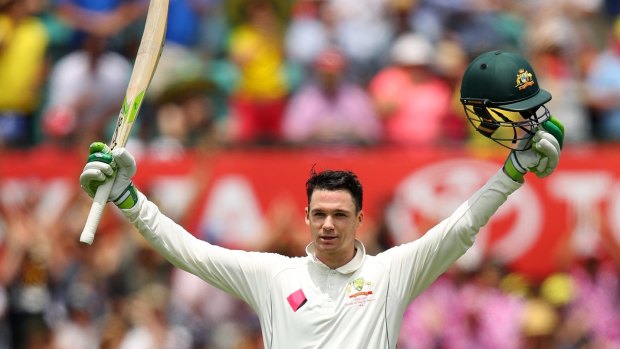 Milestone: Handscomb salutes the crowd after reaching three figures.