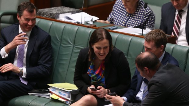 Government frontbenchers Michael Keenan, Kelly O'Dwyer, Christian Porter, and Josh Frydenberg look at their phones during question time.