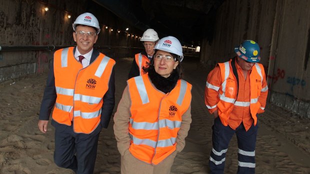 Premier Gladys Berejiklian and Transport Minster Andrew Constance don hard hats at a high-vis photo opportunity.