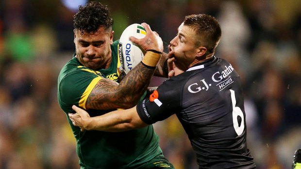 Andrew Fifita of Australia is tackled by Kieran Foran of the Kiwis during the Anzac Test match in Canberra.