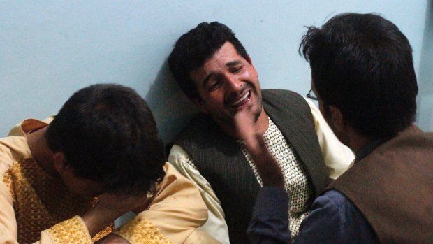 Relatives mourn after a suicide attack on a mosque in Herat, Afghanistan.