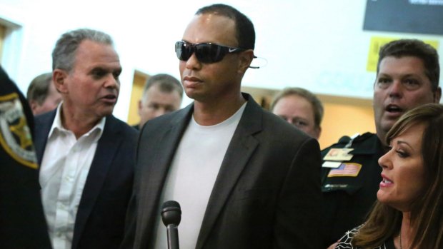 Tiger Woods leaves court in Florida after pleading guilty.