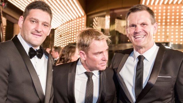 Shane Warne, flanked by Brendan Fevola and Paul Harragon, shies away from Fairfax Media's camera at the Logie Awards.