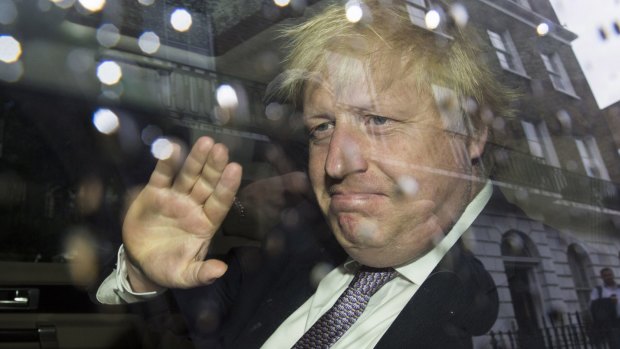 Former London Mayor Boris Johnson waves as leaves his home by car.
