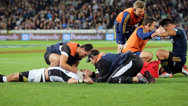 Willie Le Roux of the Sharks and Jason Emery of the Highlanders are attended to after the incident.