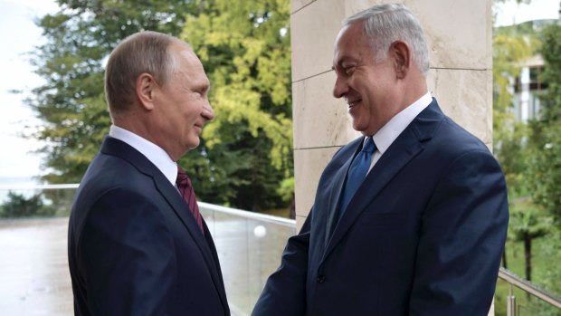 Russian President Vladimir Putin, left, and Israeli Prime Minister Benjamin Netanyahu shake hands in Sochi, Russia.