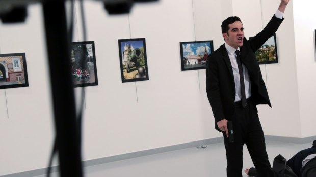 A man identified as Mevlut Mert Altintas shouts after shooting Andrei Karlov, the Russian Ambassador to Turkey.