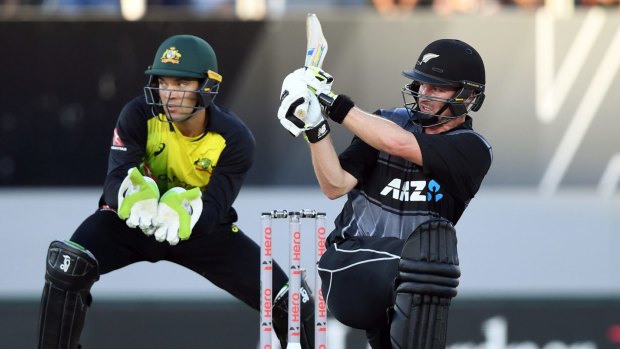 Delivery man: Colin Munro brings up his 50 sweeping in front of Alex Carey.