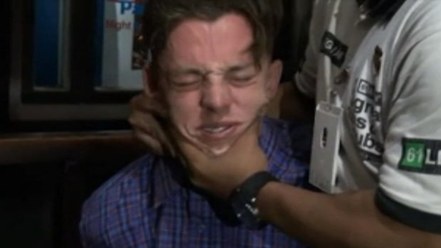 A security guard grabs Jamie Murphy on the face at the Sky Garden nightclub.