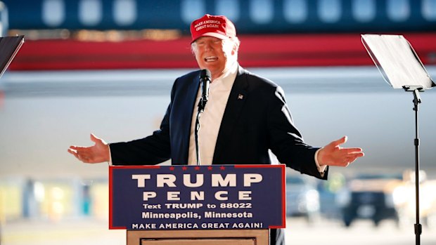 Donald Trump tells the crowd in Minneapolis that Clinton is protected by a "rigged system". 