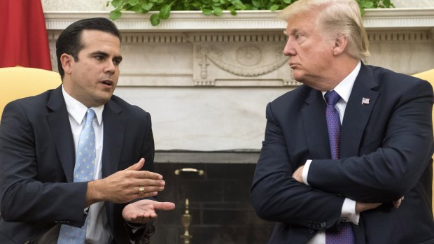 Ricardo Rossello, governor of Puerto Rico, left, speaks as U.S. President Donald Trump listens during a meeting in the Oval Office.