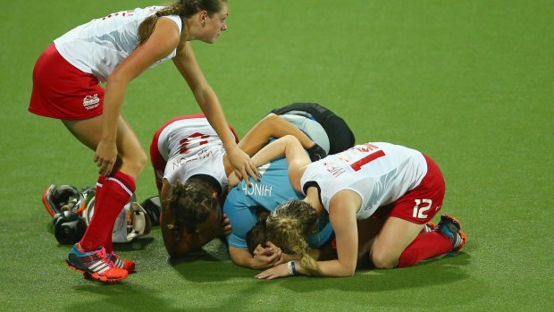 Ellie Watton, Georgie Twigg, Maddie Hinch, and Giselle Ansley of England look dejected after losing the penalty shoot out.