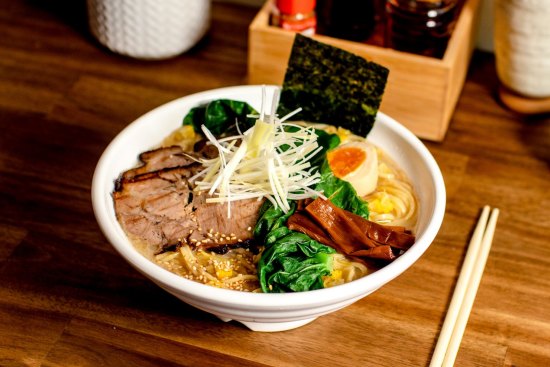 The menu's eight bowls of ramen are dominated by tori paitan broths, a rich chicken base, pictured here topped with charred pork belly.