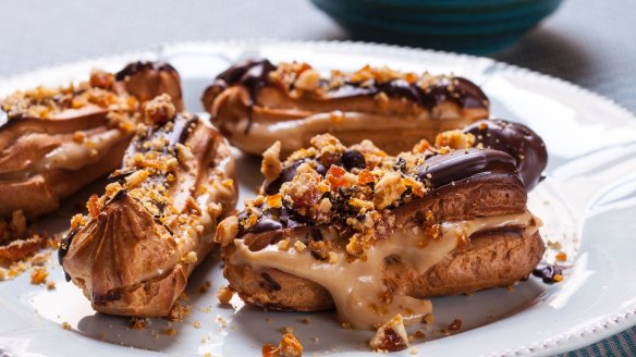 Eclairs filled with coffee cream and decorated with walnut and coffee bean praline <a href="https://www.goodfood.com.au/recipes/eclairs-20130814-2rvdd"><b>(Recipe here)</b></a>.