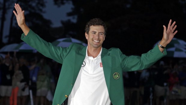 Australia's Adam Scott shows off his green jacket after winning the US Masters in 2013.