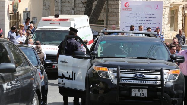An ambulance transports the body of Jordanian writer Nahed Hattar to a medical facility, after he was shot, in Amman.
