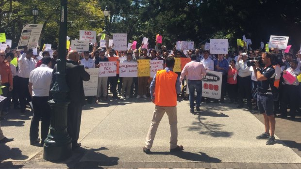 Taxi drivers protest "illegal taxi services" outside Parliament in Brisbane.