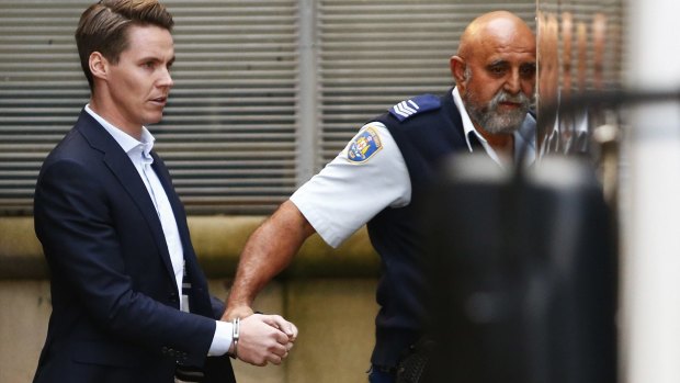 Insider trader Oliver Curtis is escorted to a prison truck after being sentenced to a maximum of two years in jail.