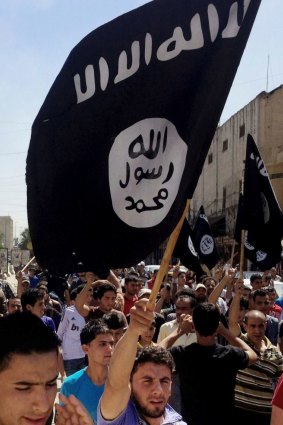 Supporters fly a Islamic State flag in Mosul in 2014.