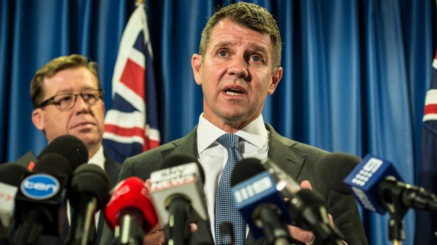 Mike Baird is flanked by Deputy Premier Troy Grant as he announces the greyhound racing ban backdown in October.