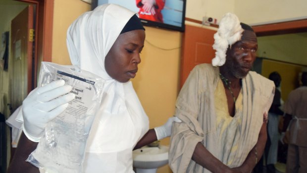 A victim of a suicide bomb attack at a refugee camp receives treatment  in Maiduguri.