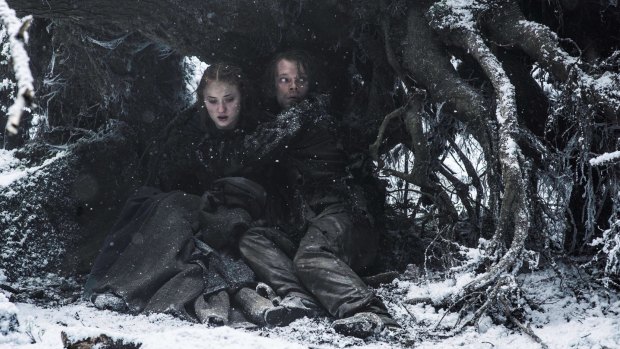 Sansa Stark (Sophie Turner) and Theon Greyjoy (Alfie Allen) hide from Ramsey in <i>Game of Thrones</i>.
