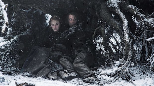 Sansa Stark (Sophie Turner) and Theon Greyjoy (Alfie Allen) hide from Ramsey in <i>Game of Thrones</i>.