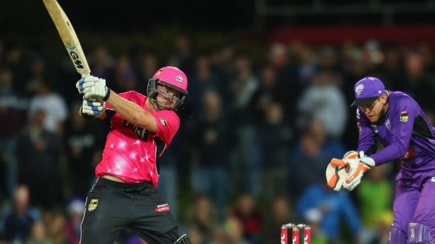 Michael Lumb of the Sixers bats as wicketkeeper Tim Paine of the Hurricanes looks on during the Big Bash League match between the Hobart Hurricanes and the Sydney Sixers