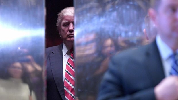 US President-elect Donald Trump in an elevator in the lobby of Trump Tower.