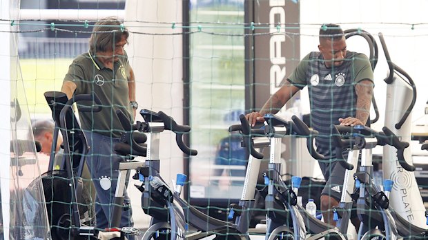 Boateng, right, warms up separately to the Germany team.