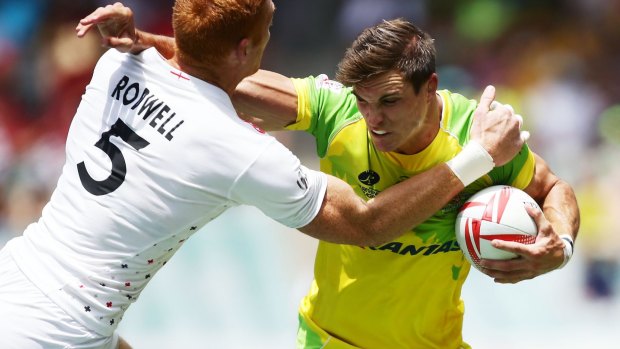 Jenkins fends James Rodwell during this year's Sydney Sevens.