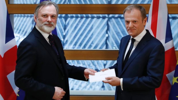 Sir Tim Barrow (left), Britain's permanent representative to the EU, hands Theresa May's Article 50 letter triggering Brexit to the European Council President Donald Tusk in Brussels.