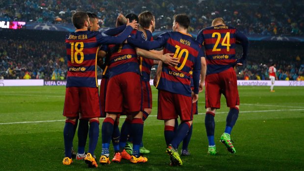 Change of scene? Barcelona players celebrate a second goal against Arsenal. 