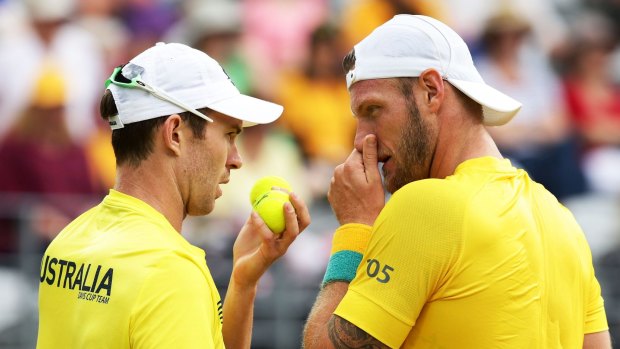 Talking tactics: John Peers and Sam Groth confer during their doubles match against Andrej Martin and Igor Zelenay of Slovakia at Sydney Olympic Park Tennis Centre.
